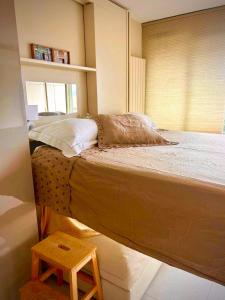 a bedroom with a large bed with a table on the floor at Studio Eden vue mer in Saint-Tropez