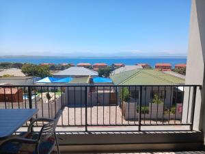 a balcony with a view of the ocean at 202 Mossel Cove in Mossel Bay