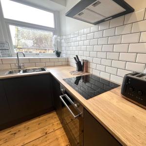a kitchen with a counter top and a sink at MOREaccom Maisonette in Morecambe +13 photos