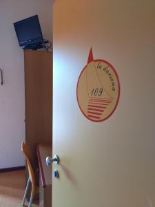 a door with a sign on the side of a room at Meublé Nautic Rooms b&b in Cesenatico +17 photos