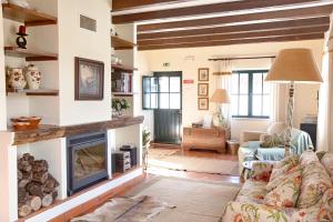 a living room with a couch and a fireplace at Quinta do Rol in Miragaia
