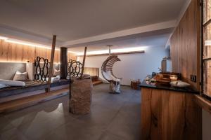 a room with two beds and a table in a room at Krahof Dolomites - Urlaub auf dem Bauernhof in Castelrotto