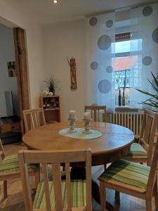a dining room with a wooden table and chairs at Im Hochparterre relaxen in Breitenbach am Herzberg