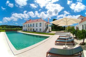 a villa with a swimming pool and a house at Quinta do Rol in Miragaia