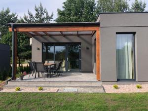 a pavilion with a table and chairs in a backyard at Natura Home in Skoki
