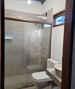 a bathroom with a shower and a toilet and a sink at Chalé À800Mts do Parq Chapada dos Veadeiros, Wi-fi in Alto Paraíso de Goiás +24 photos