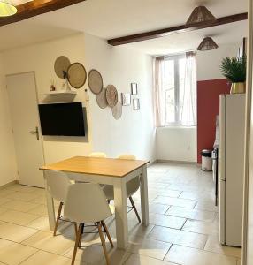 a kitchen with a table and chairs in a room at Terracotta Nougat in Montélimar