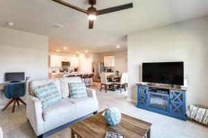 a living room with a couch and a flat screen tv at Coastal Gem with Patio and Grill in Punta Gorda! in Burnt Store Marina
