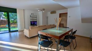 a living room with a table and a couch at Casa con piscina in Tossa de Mar