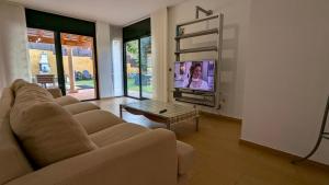a living room with a couch and a tv at Casa con piscina in Tossa de Mar