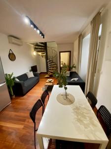 a living room with a white table and chairs at Apartment Vera - Old Town, AC, Balcony in Bratislava