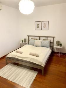 a bedroom with a bed and a white wall at Apartment Vera - Old Town, AC, Balcony in Bratislava