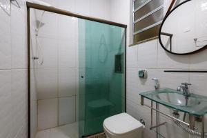 a bathroom with a sink and a toilet and a mirror at Quarto&Sala Completo a 300m da Praia | NSC 386/402 in Rio de Janeiro +35 photos