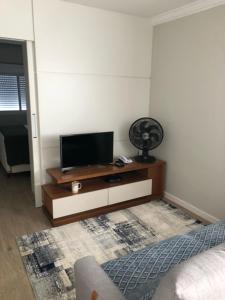 a living room with a flat screen tv on a table at Rua Dr Diogo de Faria 671 - apto 132 in Sao Paulo