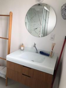 a bathroom with a white sink and a mirror at Rua Dr Diogo de Faria 671 - apto 132 in São Paulo