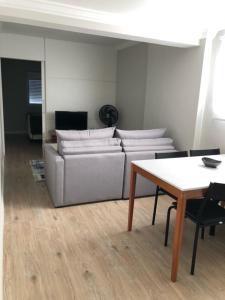 a living room with a couch and a table at Rua Dr Diogo de Faria 671 - apto 132 in Sao Paulo