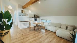 a living room with a couch and a table at Gemütliche Studiowohnung in Melsbach +6 photos