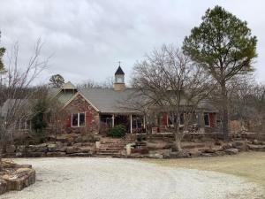 a large house with a tower on top of it at BarDew Valley Inn in Bartlesville