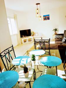 a living room with blue tables and chairs at Grand appartement 3 chambres a 300M de la plage in Sainte-Maxime
