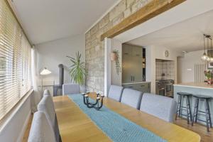 a dining room and kitchen with a table and chairs at Wyndgrove House - North East Escapes in Seahouses