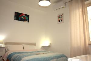 a bedroom with a bed and two pictures on the wall at Sweet Home Tempo Libero in San Severo