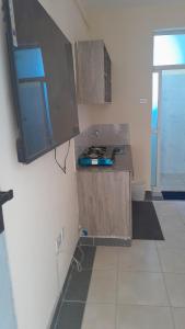 a kitchen with a counter top and a window at Mj homes in Mtwapa +11 photos