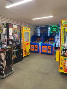 a room with arcade games and video games at Laidback n Lazy at Landmark Resort in Myrtle Beach