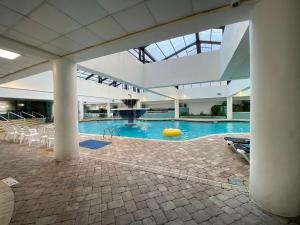 a large swimming pool with a yellow ball in a building at Laidback n Lazy at Landmark Resort in Myrtle Beach