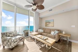 a living room with a couch and a table at Family-Friendly Gulf-Front Condo w/Beach Access in Panama City Beach +30 photos