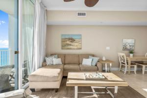 a living room with a couch and a table at Family-Friendly Gulf-Front Condo w/Beach Access in Panama City Beach