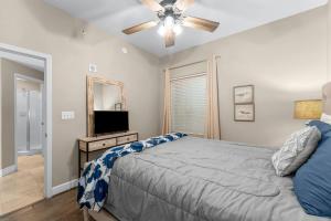 a bedroom with a bed and a flat screen tv at Family-Friendly Gulf-Front Condo w/Beach Access in Panama City Beach