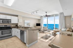 a kitchen and living room with a view of the ocean at Family-Friendly Gulf-Front Condo w/Beach Access in Panama City Beach