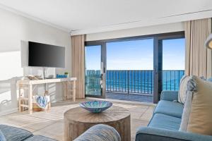 a living room with a view of the ocean at Commodore 410 in Panama City Beach +35 photos