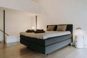 a bedroom with a large bed in a room at Magnificent loft - 3 bedroom duplex in Brussels