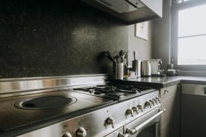 a kitchen with a stove top oven in a kitchen at Magnificent loft - 3 bedroom duplex in Brussels +40 photos