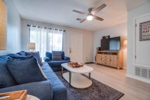 a living room with a blue couch and a tv at Softsands Hideaway - Portside Resort - Sleeps 6 in Panama City Beach