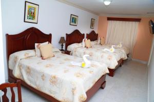 Postel nebo postele na pokoji v ubytování Hotel Los Jardines + 37 fotografií