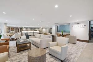 a lobby with couches and chairs and a table at The Charter at Beaver Creek C115 in Beaver Creek +4 photos