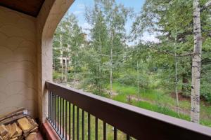 a balcony with a view of the woods at The Charter at Beaver Creek C115 in Beaver Creek