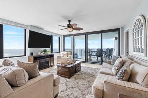 a living room with two couches and a flat screen tv at Gulf Peak Retreat - Watercrest 2 BR 2 BA - Sleeps in Panama City Beach