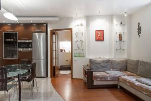 a living room with a couch and a glass table at Opera House Apartments in Vilnius