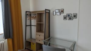 a closet with a glass shelf and a glass table at Maison chaleureuse avec jardin - Pause Normande in Sées +17 photos