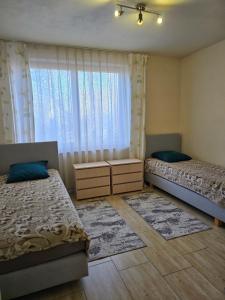 a bedroom with two beds and a window at Pokoje gościnne na terenie Chojnowskiego Parku Krajobrazowego in Ławki +14 photos