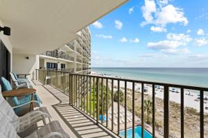 a balcony with a view of the beach at Commodore 606 3 BR 3 BA Sleeps 12 in Panama City Beach