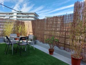a patio with a table and chairs and a fence at 10m Casco Viejo in Bilbao