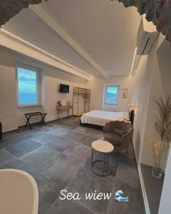 a bedroom with a bed and a couch and a table at The Orange Garden in Corniglia