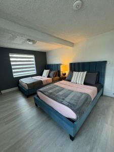 a bedroom with two beds and a window at Exquisite Miami Retreat By Miami Int Airport in Miami