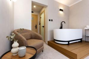 a living room with a bath tub in a room at AMAR Design Hotel by HMG in Sofia