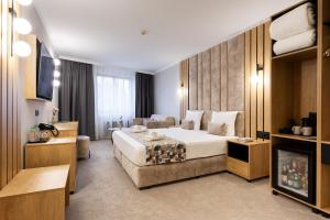 a hotel room with a large bed and a television at AMAR Design Hotel by HMG in Sofia