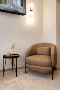a chair and a table in a room at AMAR Design Hotel by HMG in Sofia